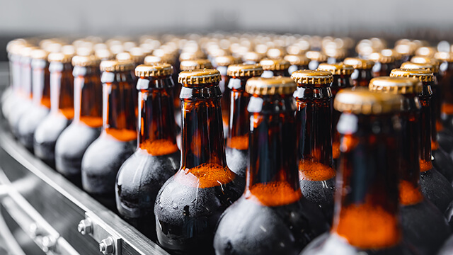 Brown beer bottles on conveyor belt