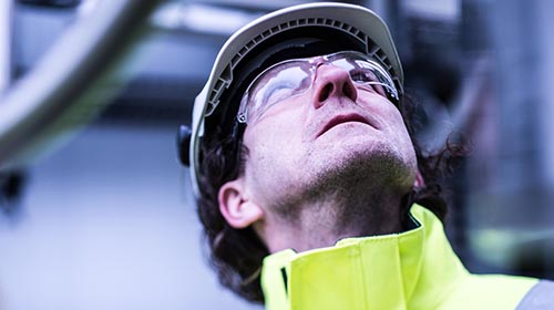 oil refinery worker outside looking up